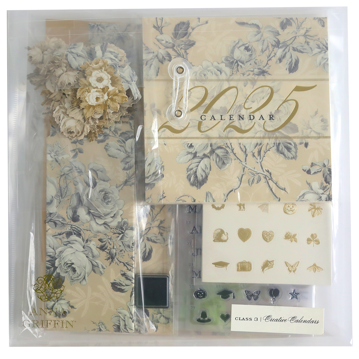 Explore the Creative Calendar Stamps, Dies and Materials kit, a 2025 calendar set featuring floral designs, decorative elements, and illustrations. This comprehensive package includes stickers, flower embellishments, and assorted paper items in muted tones, all elegantly arranged in a clear bag.