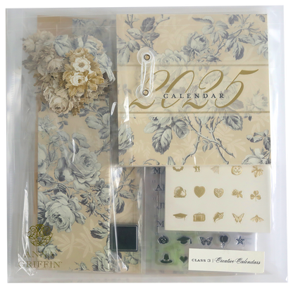 Explore the Creative Calendar Stamps, Dies and Materials kit, a 2025 calendar set featuring floral designs, decorative elements, and illustrations. This comprehensive package includes stickers, flower embellishments, and assorted paper items in muted tones, all elegantly arranged in a clear bag.