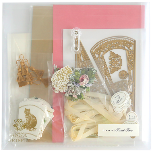 The French Fans Dies and Materials kit includes luxury matte foil cardstock, gold die cuts, pink and beige cardstock, floral embellishments, tassels, and ribbon. Unleash creativity and elegance with every piece.