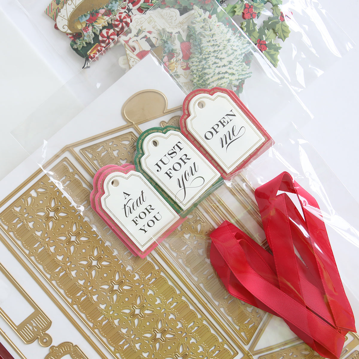 The Treat Boxes Dies and Materials feature gift tags with messages like "a treat for you," "just for you," and "open me," all beautifully complementing red ribbons. Decorative cardstock cutouts add extra flair, making them ideal when paired with 3D embellishments.
