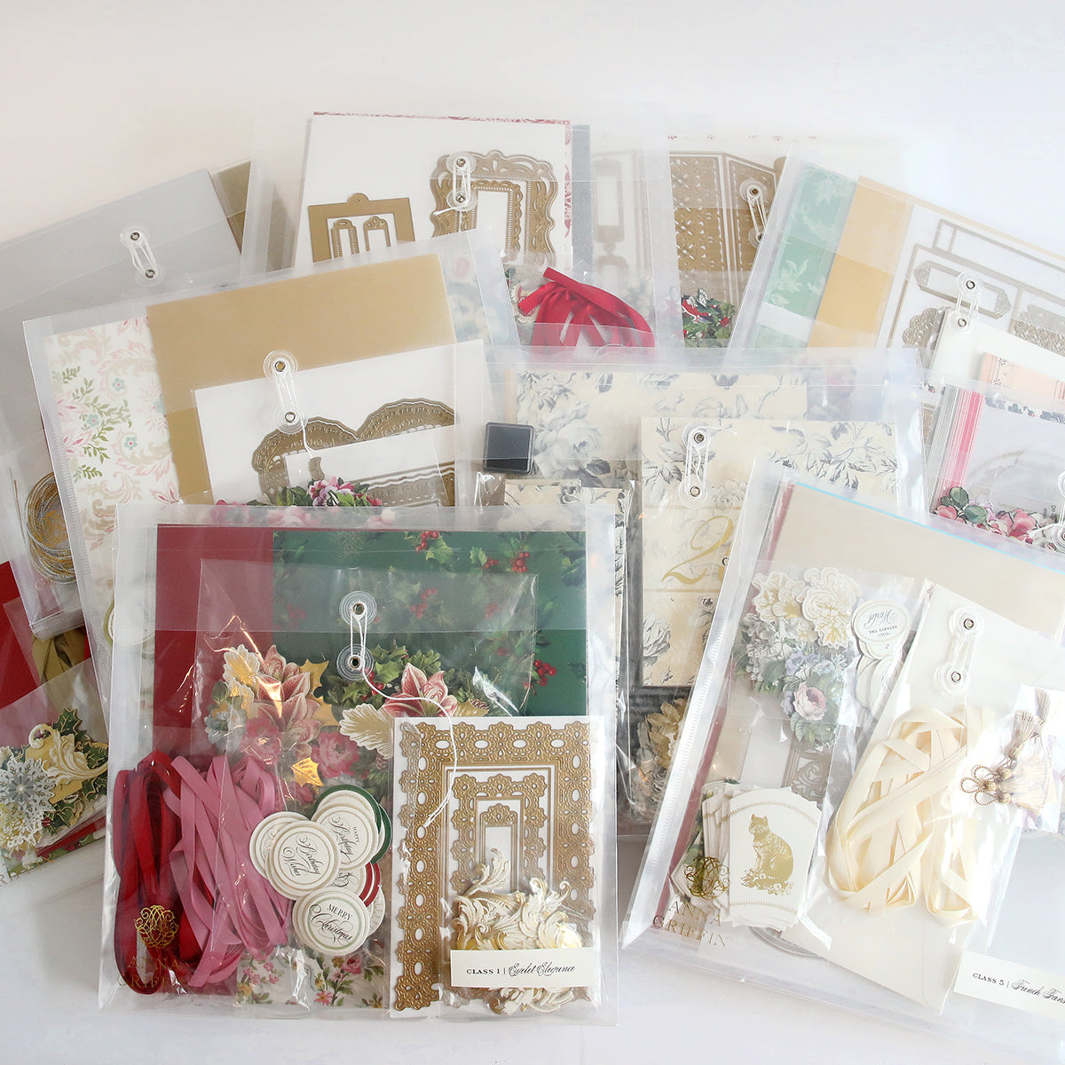 Introducing "Create 10 Boxes, Dies and Materials," a selection of craft paper kits with floral and decorative designs, ideal for crafting unique cards. Each set is neatly organized in clear plastic bags and includes optional dies and materials to enhance your creativity.