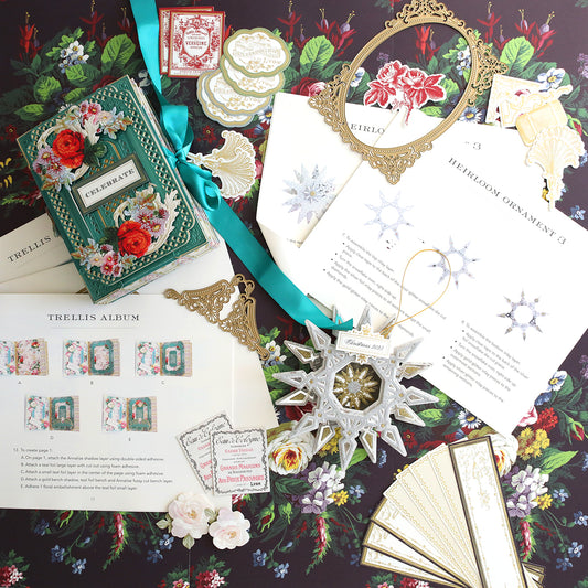 A collection of Create 9 Class Instructions cards, papers, and ornaments are laid out on a table featuring a variety of color photos.