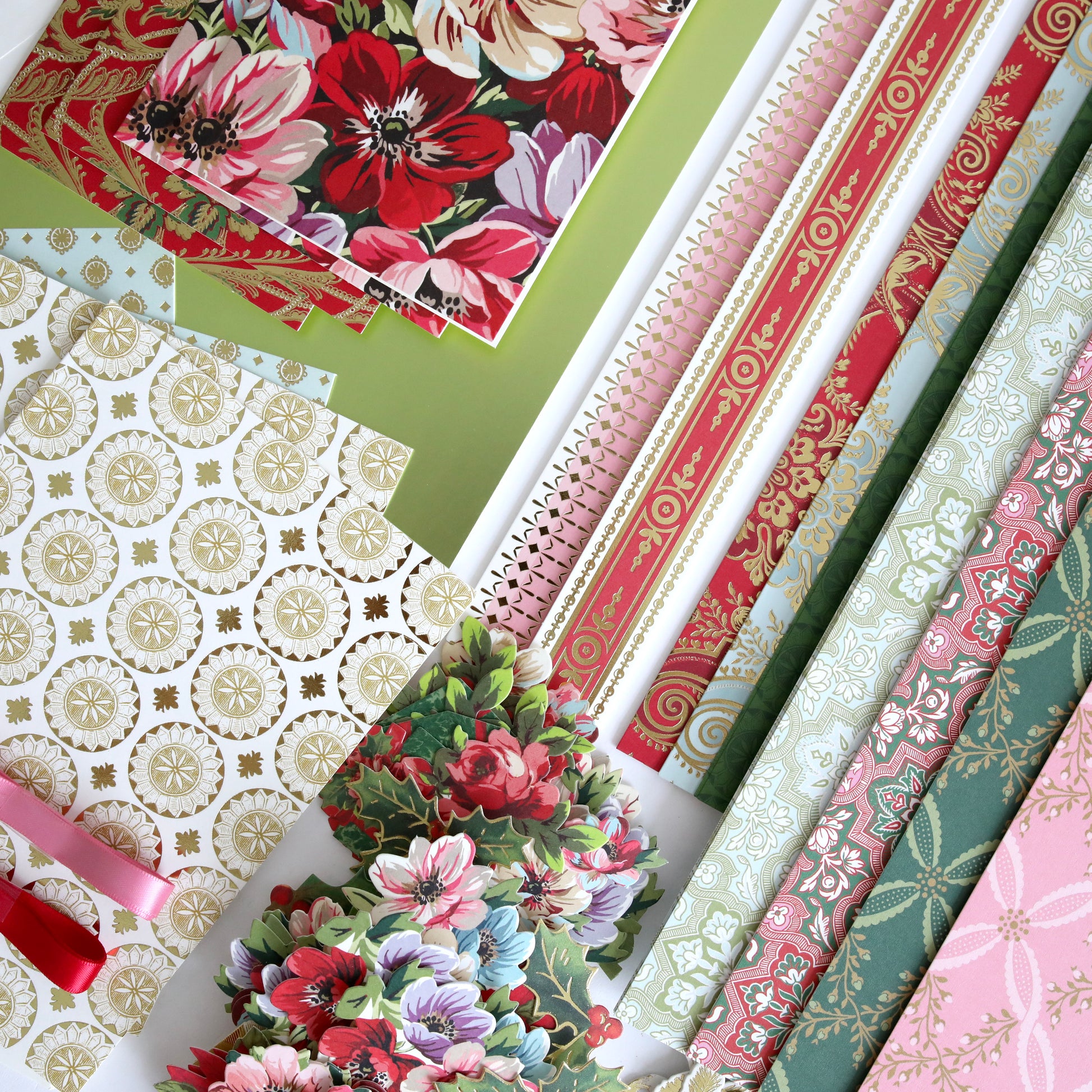 Anna Griffin | Create 2025 features floral and patterned stationery—like notebooks, decorative paper, and cut-out flowers—beautifully arranged for demonstrating crafting techniques at any papercrafting event.