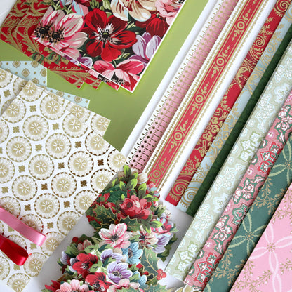 Anna Griffin | Create 2025 features floral and patterned stationery—like notebooks, decorative paper, and cut-out flowers—beautifully arranged for demonstrating crafting techniques at any papercrafting event.