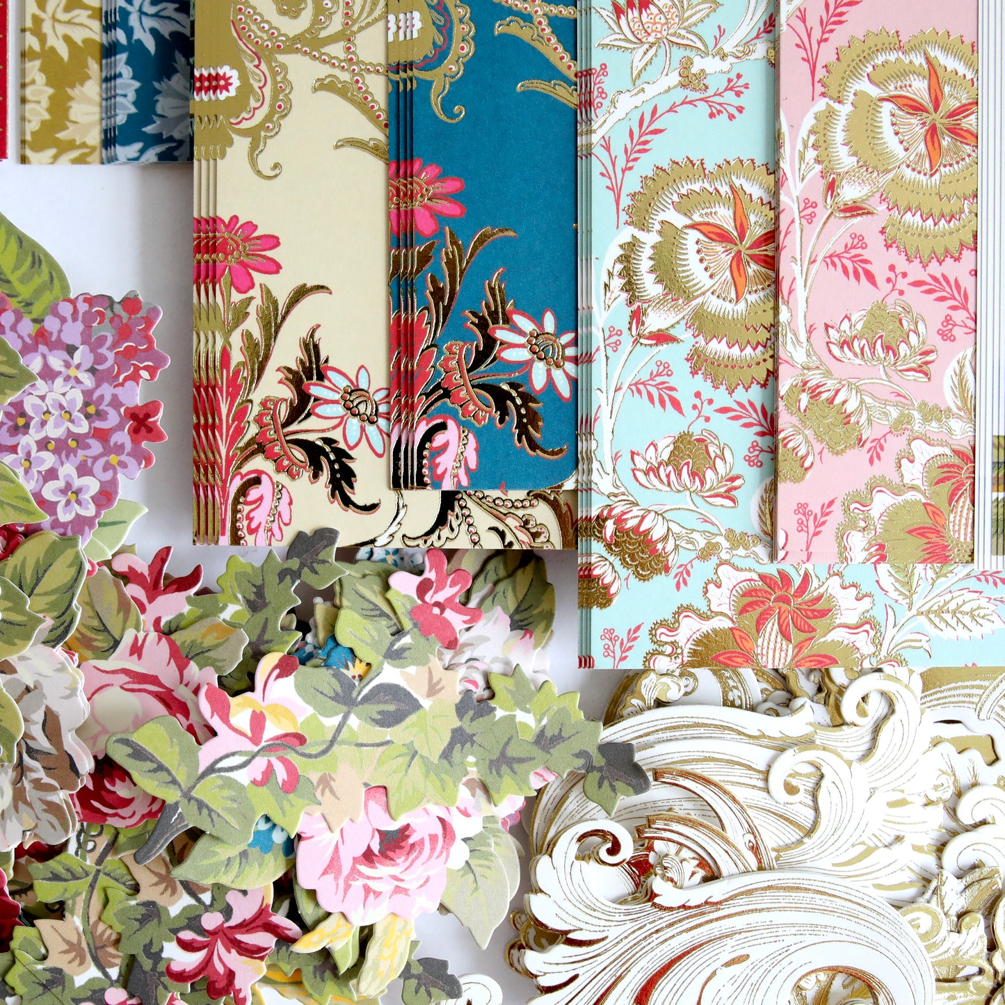 Get inspired for your next papercrafting event with Anna Griffin | Create 2025—vintage floral wallpaper samples in various colors, plus cut-out paper flowers and scroll designs, perfect to explore new crafting techniques.