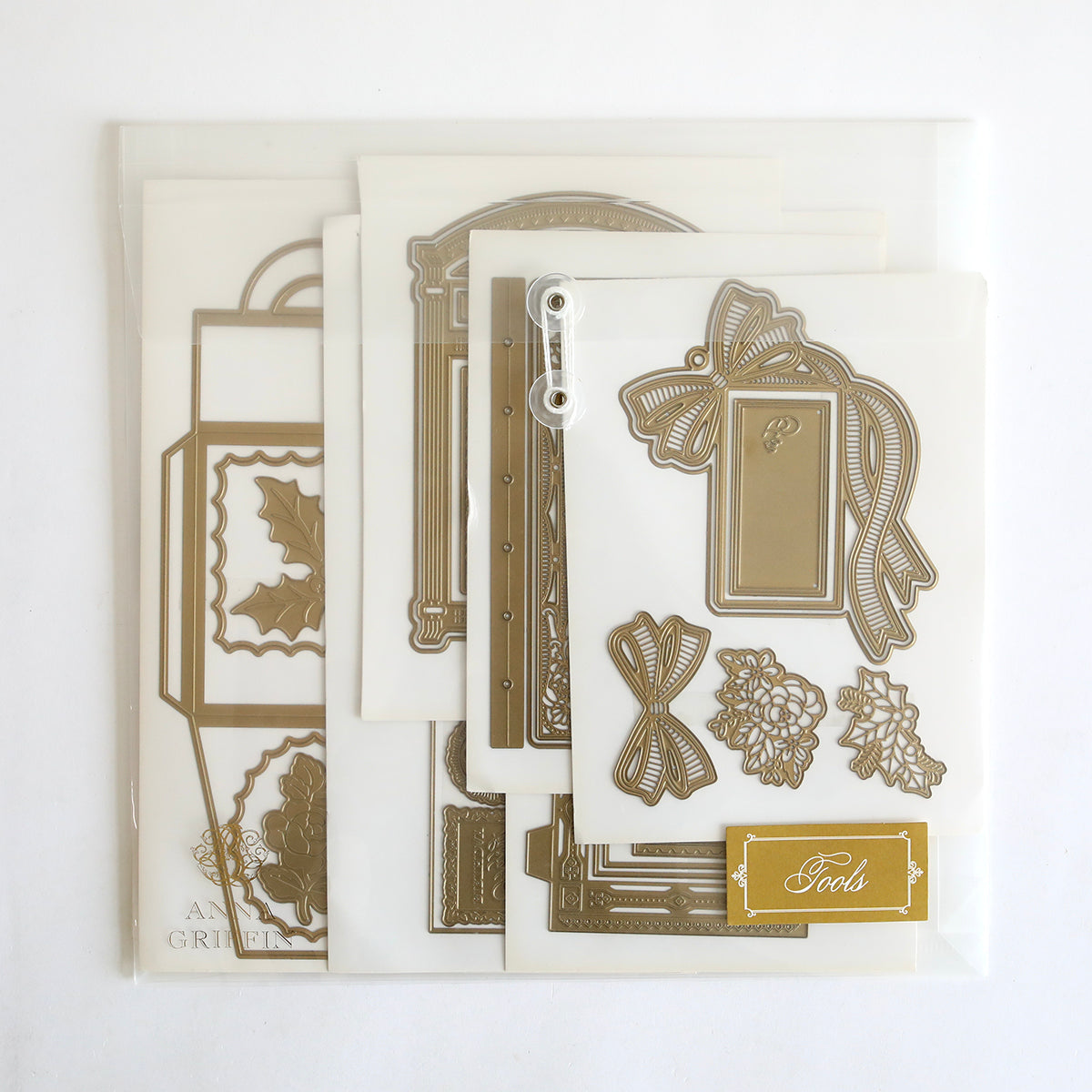 The Anna Griffin | Create 2025 set features assorted metal die cuts—floral, bow, holly, and frames—in a clear envelope, ideal for exploring new techniques or sharing in your next live-streaming papercrafting class.