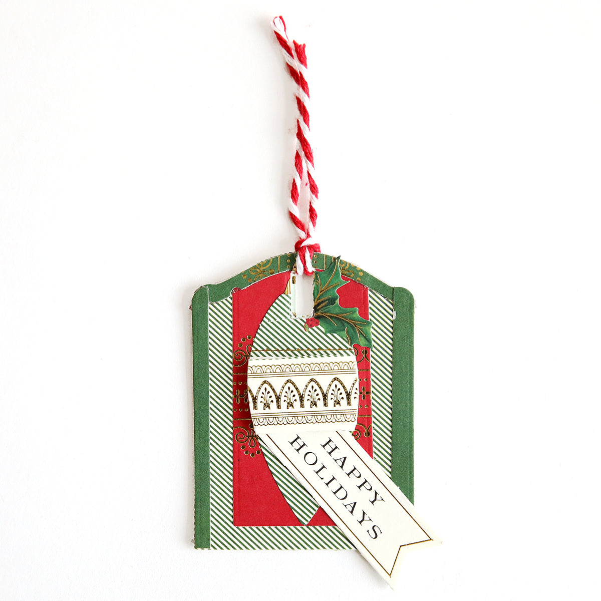 Add a festive touch to your gifts with Creative Tag Dies—features red, green, and white colors, an ornament design, "Happy Holidays" message, and red-white twisted string for unique handmade tags.