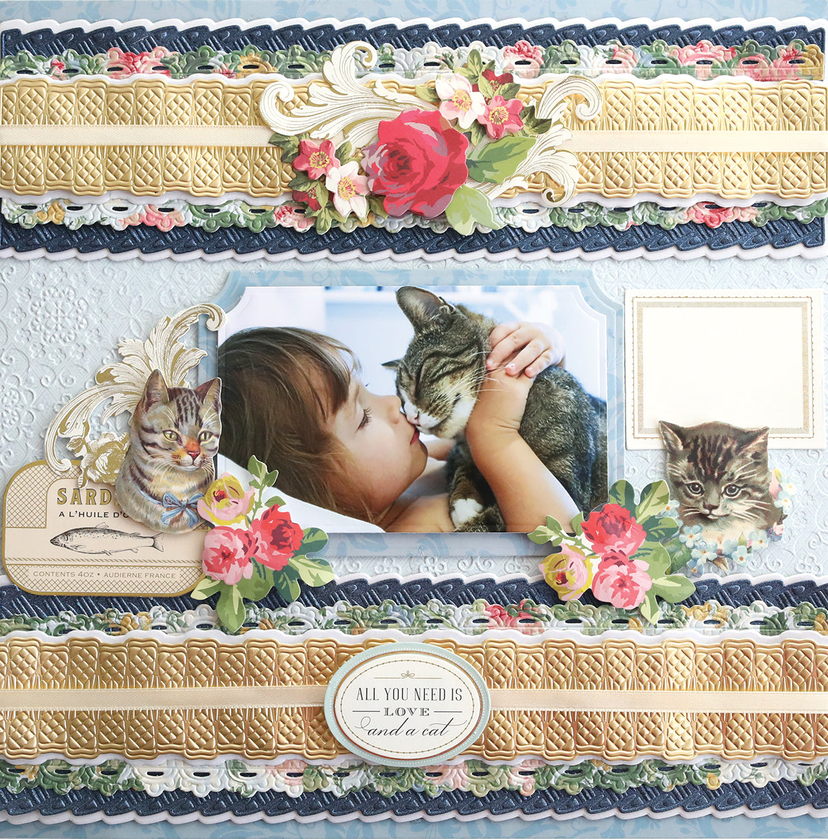 Scrapbook page featuring a person nuzzling a cat, floral decorations using cut and emboss dies, and text reading "All you need is love... and a cat." Two additional cat images, ornate frames, and 3D Ribbon Border 12" Dies are included.
