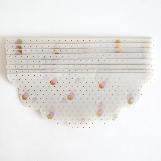 A stack of Lavender & Gold Dots Vellum Wraps (10 pack) featuring gold polka dot invitations and pastel circle patterns, arranged on a white background.