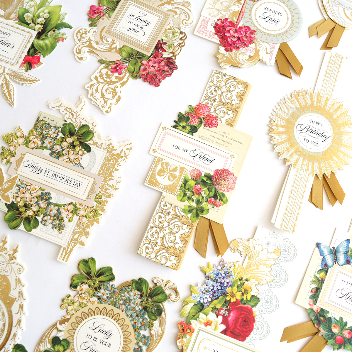Delightful Collage Toppers and Cards: elegant cards with floral and gold patterns, assorted messages, decorative ribbons, and card toppers arranged on a white background.
