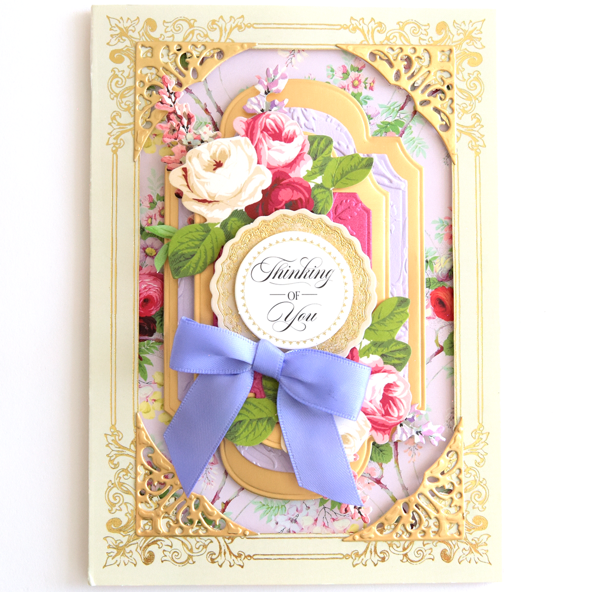 A Thanksgiving Greetings Bundle card featuring a floral background, a scalloped “Thinking of You” label, and a purple ribbon bow, all framed by a gold filigree border.