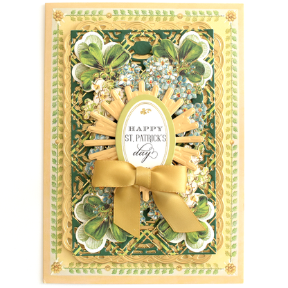 The Delightful Collage Toppers and Cards set includes a decorative St. Patrick's Day card with gold accents, floral and clover designs, a gold ribbon bow, and "Happy St. Patrick's Day" in the center—ideal for festive cardmaking projects.