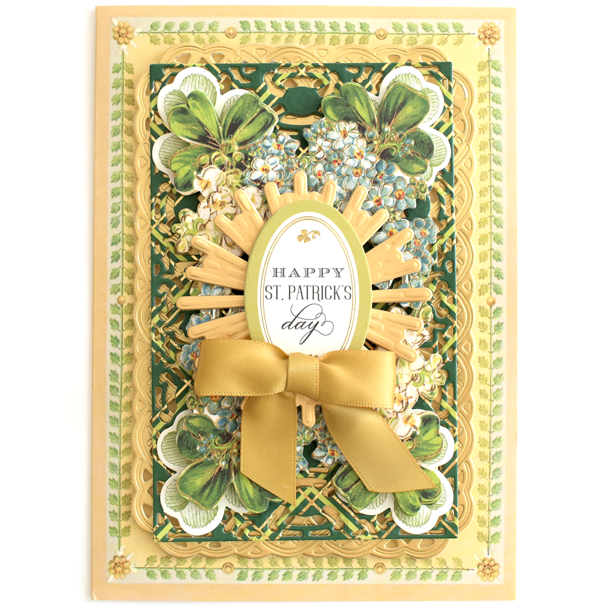 A layered, decorative Thanksgiving Greetings Bundle card featuring a central oval that reads “Happy St. Patrick’s Day,” accented with a gold ribbon and floral motifs, similar to autumn embellishments.