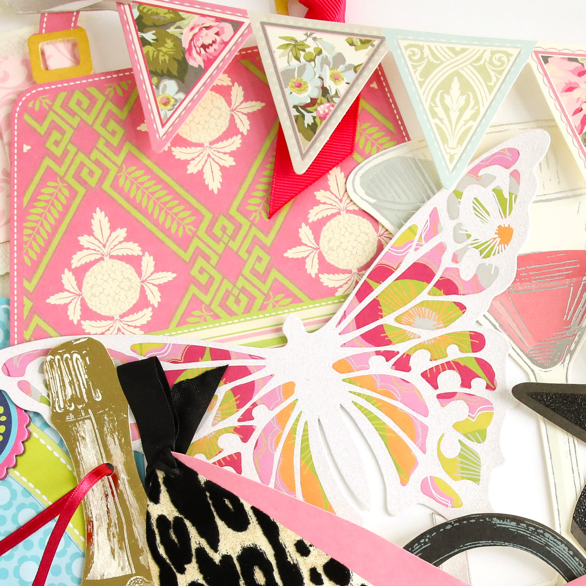 The All Occasion Extreme Diecut Assortment features a vibrant mix of butterfly cutouts, floral banners, animal prints, and other decorative elements arranged in a layered display—ideal for embellishing handmade cards or adding flair to scrapbook pages with unique diecut images.