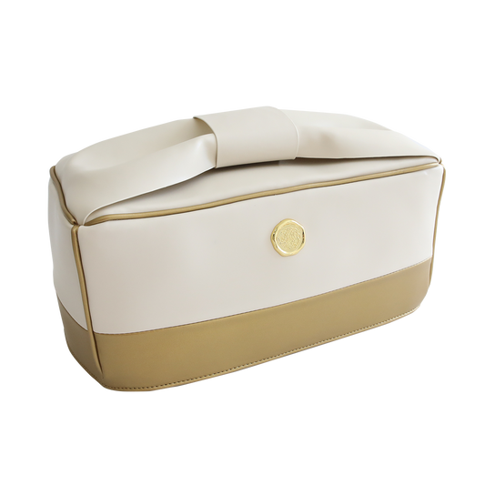 The Empress Elite or Empress Dust Cover is a two-tone beige and cream rectangular bag, featuring a wide handle and a round gold emblem on the side, ideal for transporting your crafting essentials from the die-cutting machine in your craft room.