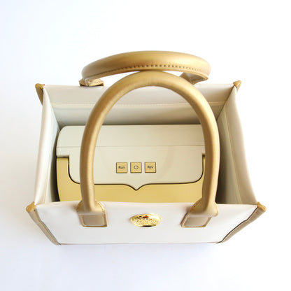 An Empress Mini Tote and Dust Cover, featuring a white and gold design, includes a small box inside.