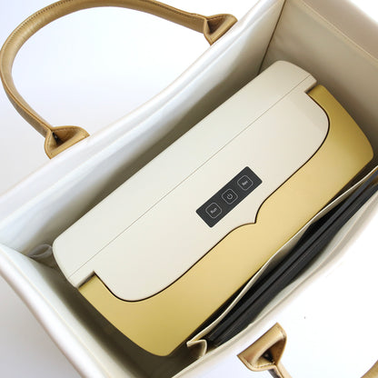 A portable electronic device is placed inside an elegant Empress Machine Tote Bag, aligning with the bag's Ivory palette.