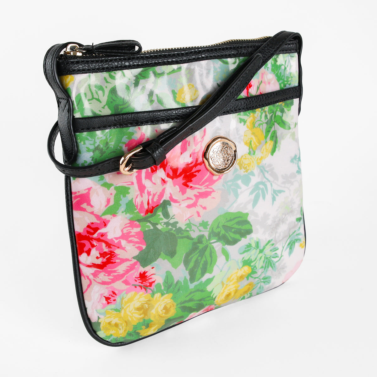 The Virginia Crossbody features a beautiful floral pattern with black trim, a gold decorative emblem, and a matching black shoulder strap. Displayed on a white background, this stylish crossbody bag makes an ideal gift for women. Crafted from durable laminated cotton, the Virginia Crossbody blends elegance and practicality for effortless everyday use.