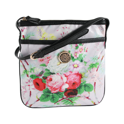 The Lillian Crossbody is a square crossbody purse featuring a black strap, gold buckle, and an elegant floral design with red, pink, and white flowers set against a light background. Crafted from durable laminated cotton, this stylish floral bag is perfect for everyday wear.