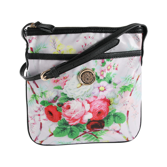 The Lillian Crossbody is a square crossbody purse featuring a black strap, gold buckle, and an elegant floral design with red, pink, and white flowers set against a light background. Crafted from durable laminated cotton, this stylish floral bag is perfect for everyday wear.