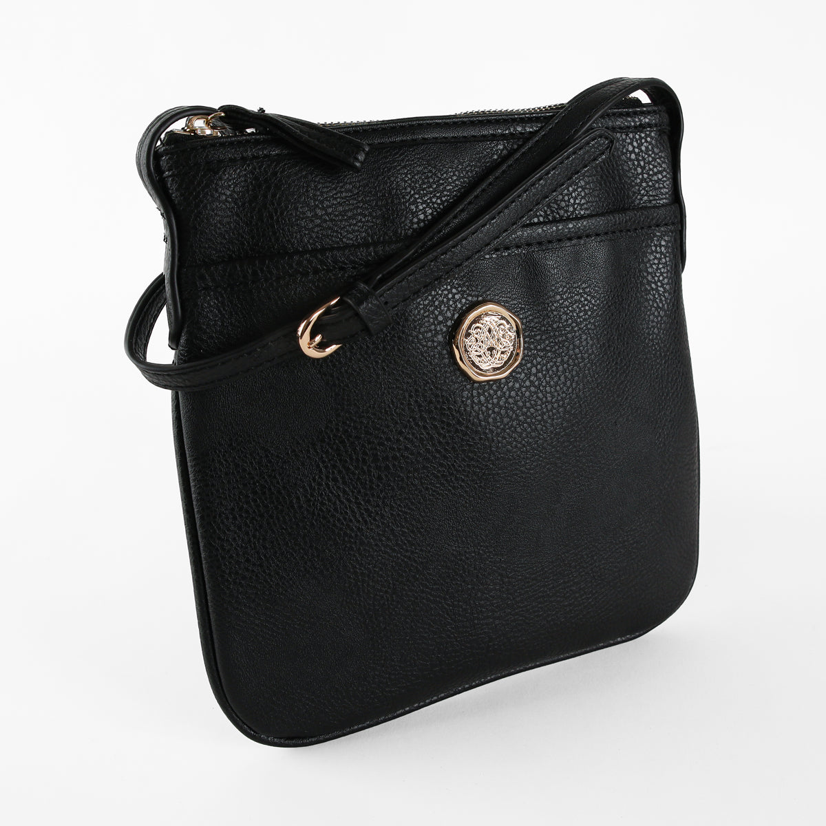 Onyx Black Crossbody Bag crafted from faux leather, highlighted by a gold emblem on the front, features a zippered top and an adjustable shoulder strap, displayed against a plain white background.