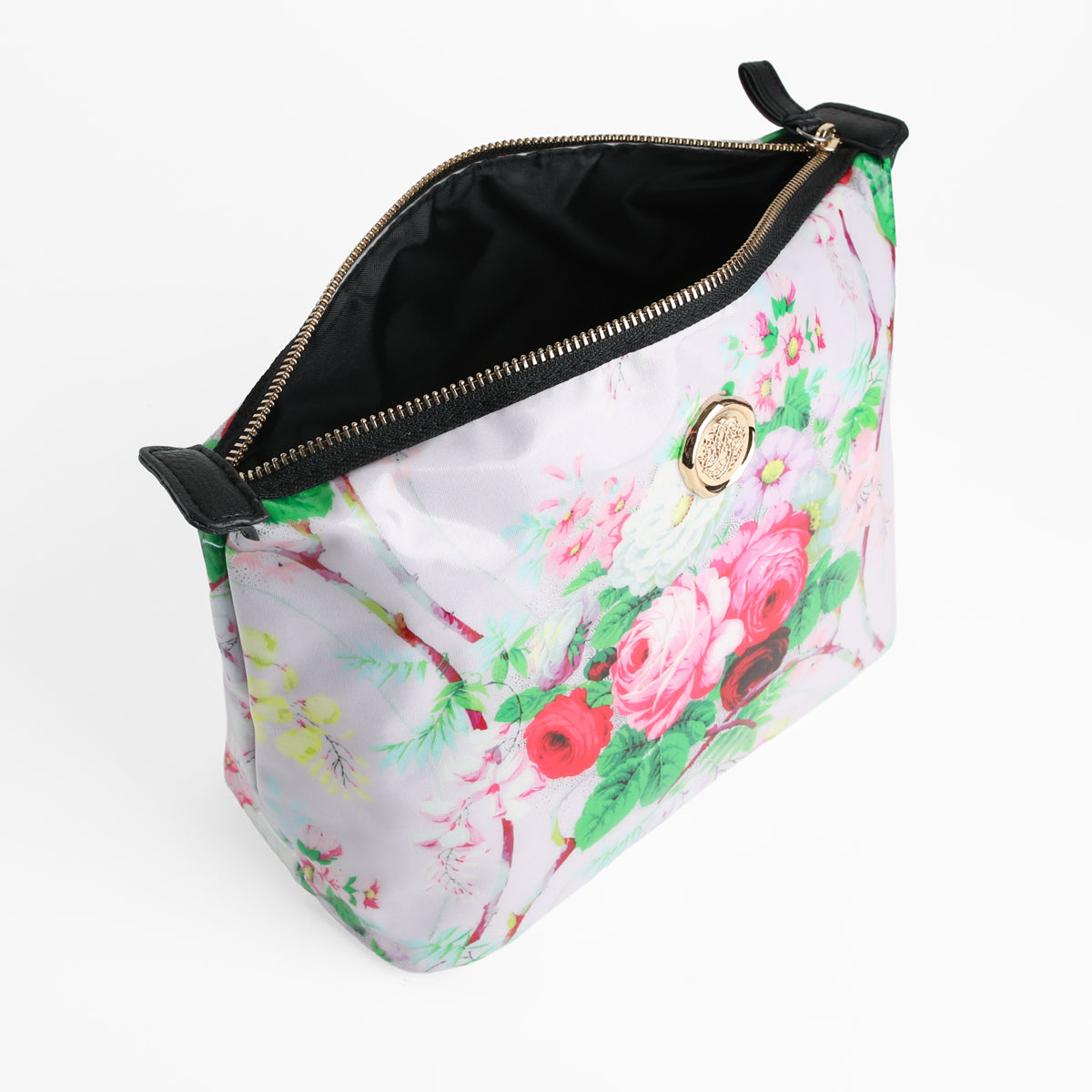 The Lillian Large Cosmetic Bag features an open floral pattern, a gold medallion detail, and a black zipper. Its spacious black interior makes it perfect for use as a stylish travel organizer or cosmetic bag.