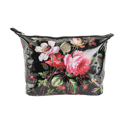 The Noire Large Cosmetic Bag features a black zippered pouch design with a glossy finish, adorned with pink and red floral patterns and a gold circular emblem at the center—making it the perfect stylish makeup bag or travel organizer to keep your essentials neatly stored.