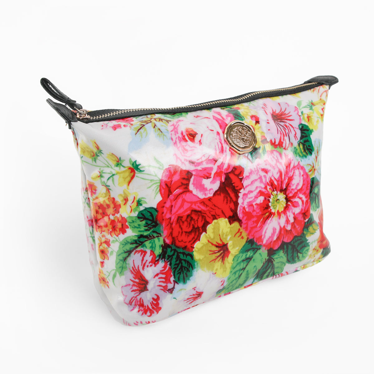 The Annalise Large Cosmetic Bag is a zippered pouch adorned with a floral pattern in pink, red, yellow, and green tones, featuring a round gold emblem on the front—perfect as a travel organizer or makeup bag for stylish storage on the go.