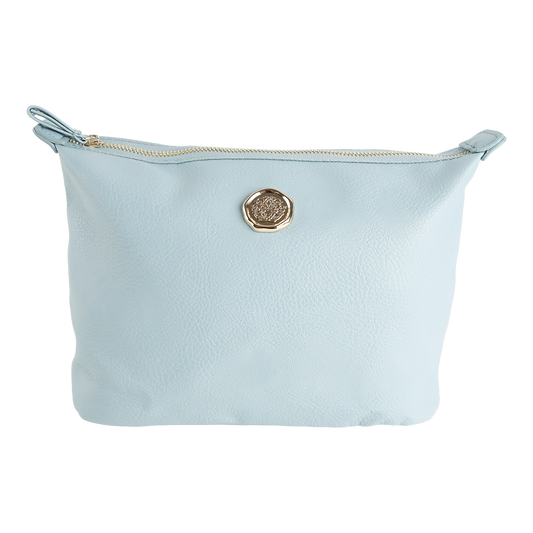 Introducing the Beach Glass Blue Large Cosmetic Bag, crafted from blue faux leather with a textured surface and finished with a round gold emblem at the center. This spacious pouch features a gold-toned zipper along the top edge, making it an ideal and stylish choice for organizing your travel makeup essentials.