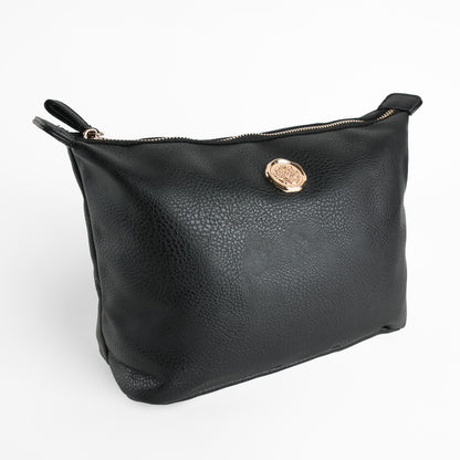 Introducing the Onyx Black Large Cosmetic Bag—a sleek black leather zippered pouch adorned with a gold emblem on the front, photographed against a plain white background. Perfect as a chic travel cosmetic bag or an elegant makeup bag for your everyday essentials.