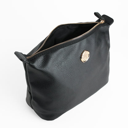 The Onyx Black Large Cosmetic Bag features black leather with a gold emblem on the front and is shown open to reveal its interior lining.