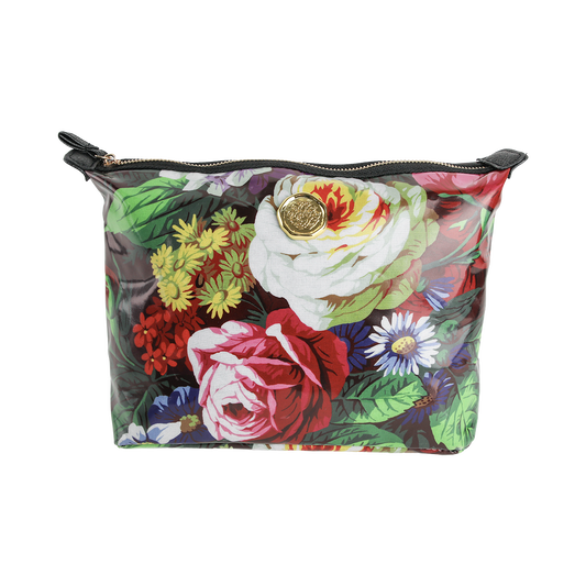 The Astrid Large Cosmetic Bag is a colorful laminated cotton zippered pouch with a floral print featuring roses and daisies, accented by a round gold emblem on the front—perfect as a large makeup bag or floral cosmetic bag.