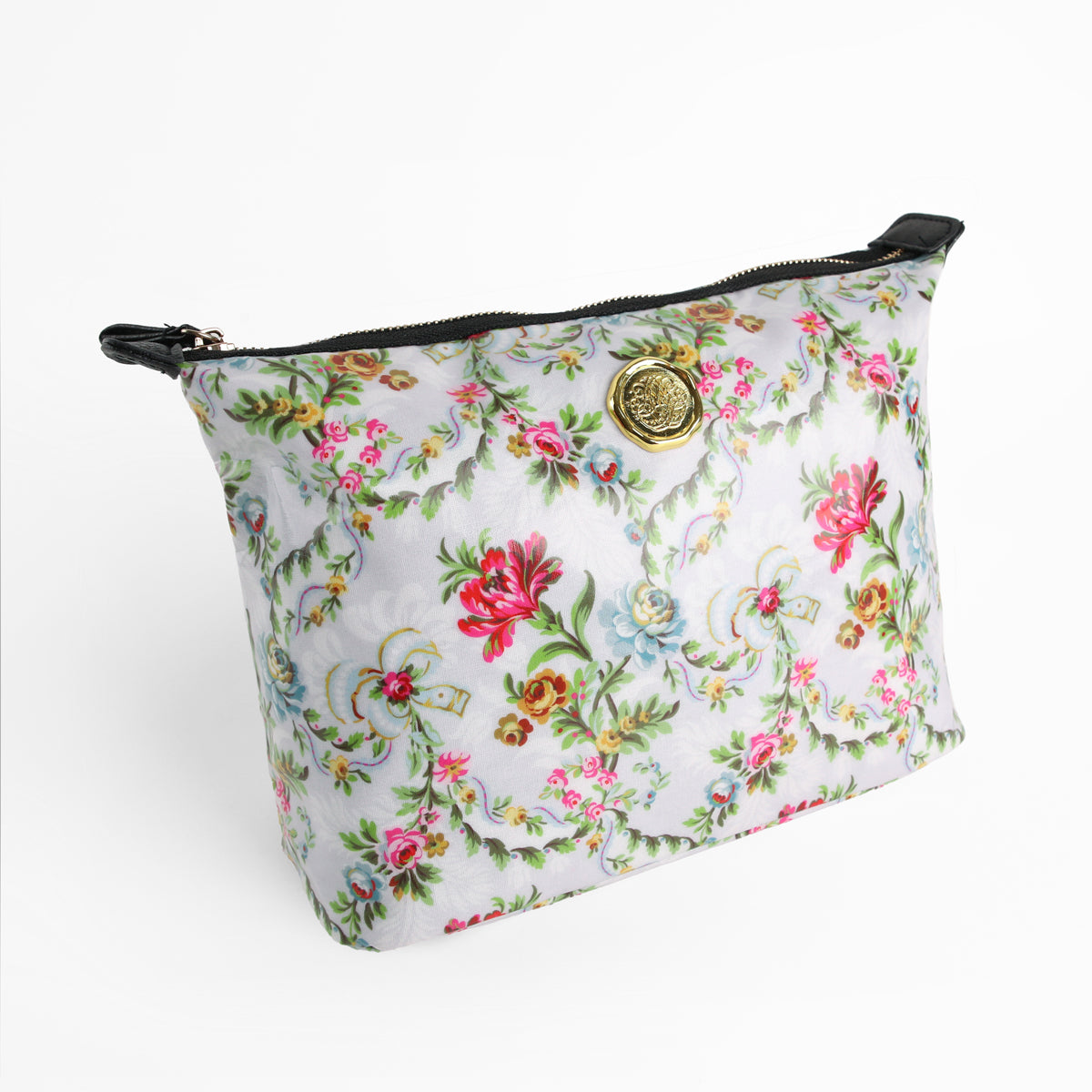 The Phoebe Large Cosmetic Bag, crafted from laminated cotton in a floral pattern and adorned with a gold medallion detail on the front, is displayed against a white background. Combining style with practical durability, this spacious bag is perfect as a floral travel makeup pouch.