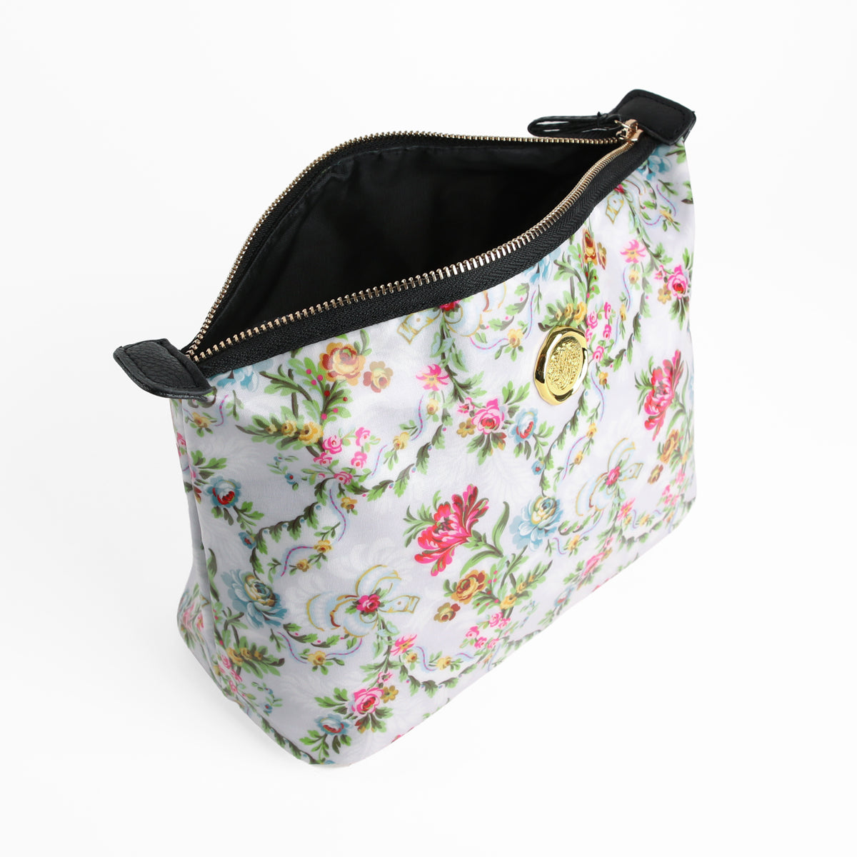 Phoebe Large Cosmetic Bag — a stylish floral-patterned laminated cotton handbag featuring a black interior, gold zipper, and circular gold emblem on the front, shown partially open against a white background; perfect as a large floral travel makeup bag.