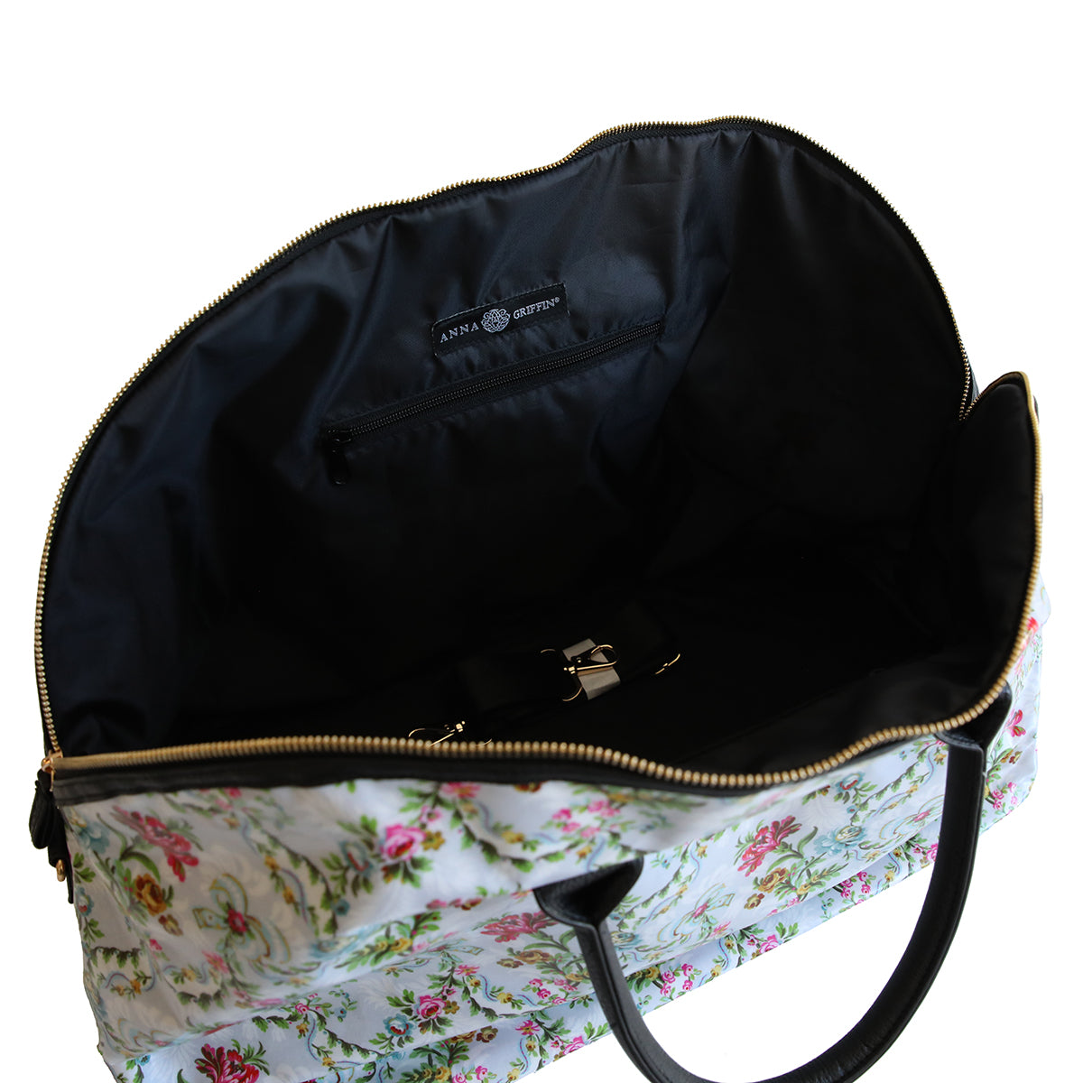 Open Phoebe Duffle Bag with a nylon interior, displaying an inner zipper pocket and gold-tone hardware.