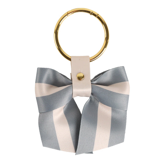 Introducing the Gray Stripe Bag Charm – a stylish women’s keychain featuring a gold ring and a gray and white striped ribbon bow, accented by a white leather strap with a gold stud. It’s the perfect purse charm to elevate any handbag accessory collection.