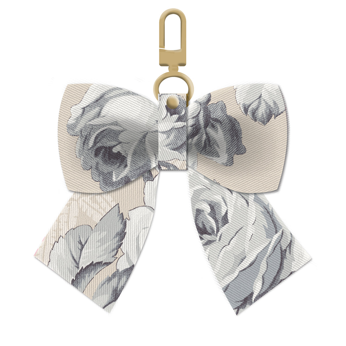 The Faded Rose Bag Charm is a sophisticated clip-on bow with a floral pattern in muted gray tones, elegantly secured with a gold clasp, perfect for adding subtle charm to any bag.