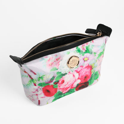 The Lillian Small Cosmetic Bag, featuring a floral print, gold circular emblem, and black accents, is shown open against a white background—this stylish zippered pouch is perfect for keeping your essentials organized while traveling.