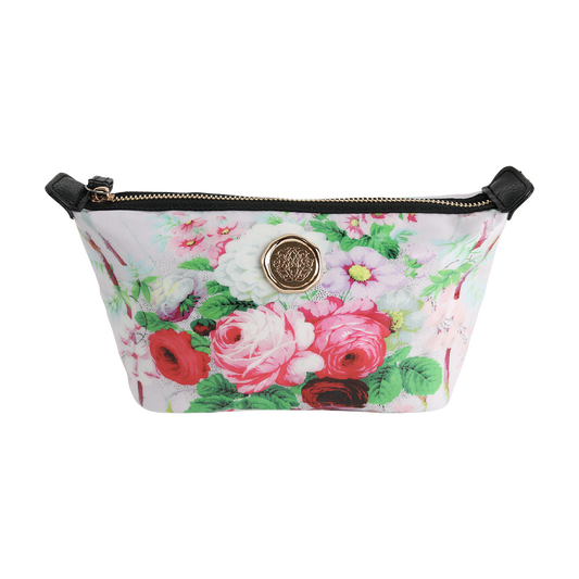The Lillian Small Cosmetic Bag features a zip-top design with a floral print, black straps, and a central round gold emblem on a white background—perfect for carrying your essentials as a small cosmetic or travel makeup bag.