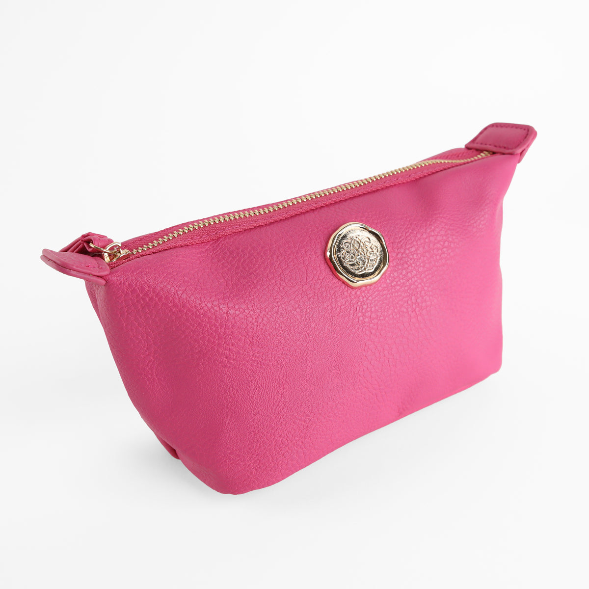 The Raspberry Pink Small Cosmetic Bag features a bright pink faux leather exterior with a gold emblem on the front and a zippered closure, making it ideal for use as a small makeup bag or travel cosmetic pouch. It is shown against a plain white background.