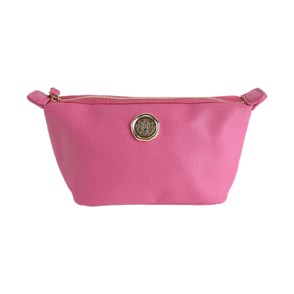 The Raspberry Pink Small Cosmetic Bag, made from faux leather and featuring a gold emblem on the front, is a zippered pouch shown against a plain white background.