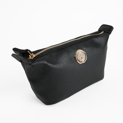 The Onyx Black Small Cosmetic Bag, featuring black faux leather with a gold zipper and a round gold emblem on the side, is displayed against a plain white background.