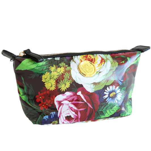 Colorful floral patterned Astrid Small Cosmetic Bag with a zipper and a gold emblem on the side, isolated on a white background.