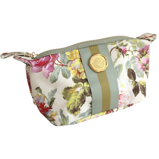 The Francesca Small Cosmetic is a durable cotton bag with a floral pattern, zipper closure, green and gold ribbon accent, and a round gold emblem—ideal for organizing your travel essentials.