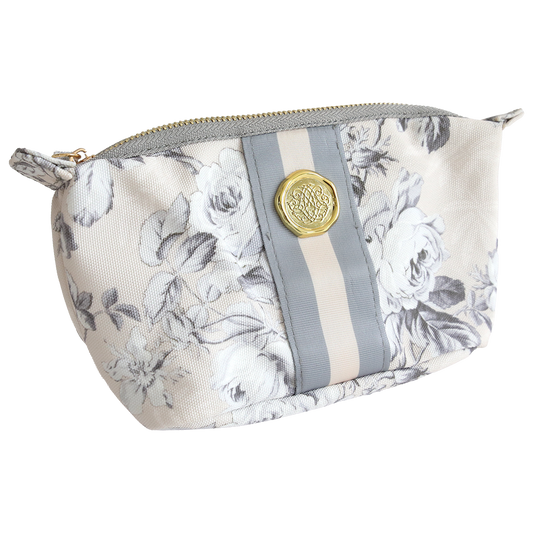 The Faded Rose Small Cosmetic is a durable cotton pouch with a floral pattern, gray and beige vertical stripe, gold front emblem, and zipper—ideal for storing travel essentials.