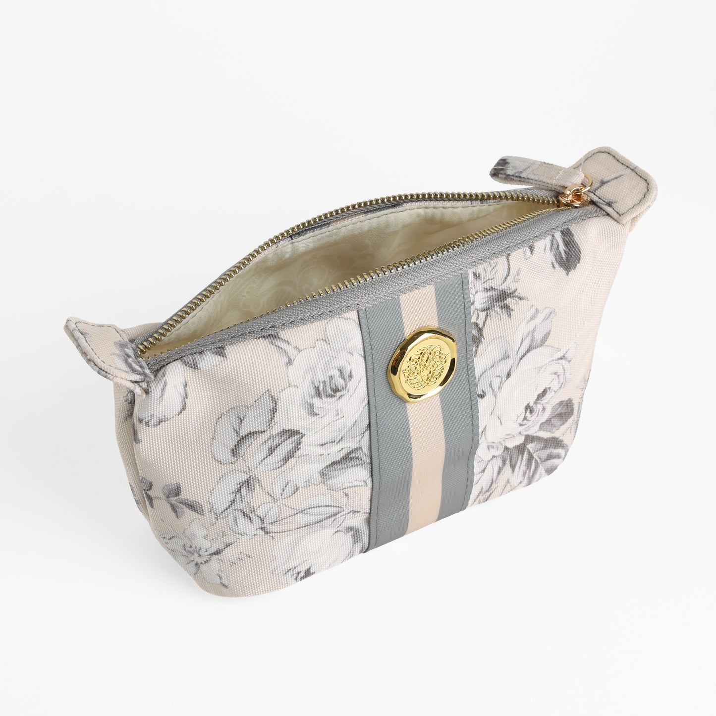 The Faded Rose Small Cosmetic Bag features a subtle beige and gray floral pattern, a gold zipper, and a circular gold emblem on the front—perfect as a compact makeup pouch or travel bag for your everyday essentials.