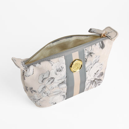 The Faded Rose Small Cosmetic Bag features a subtle beige and gray floral pattern, a gold zipper, and a circular gold emblem on the front—perfect as a compact makeup pouch or travel bag for your everyday essentials.