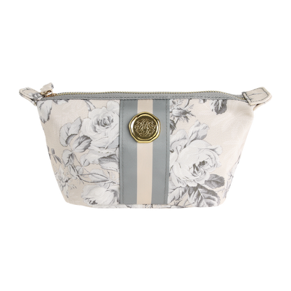 Introducing the Faded Rose Small Cosmetic Bag—a stylish zippered pouch showcasing a gray and white floral pattern, accented with vertical gray and beige stripes and finished with a gold medallion detail on the front. Perfect as a chic cosmetic pouch or a convenient travel bag.