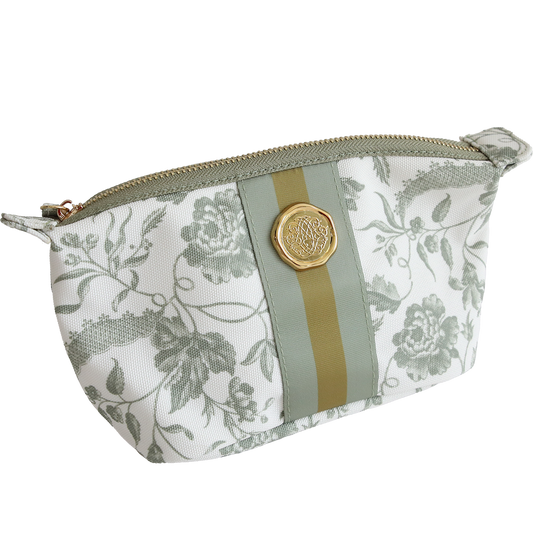 The Green Climbing Rose Small Cosmetic is crafted from durable cotton with a green floral print, gold and green stripe, and round gold emblem—a chic and practical travel bag for your essentials.