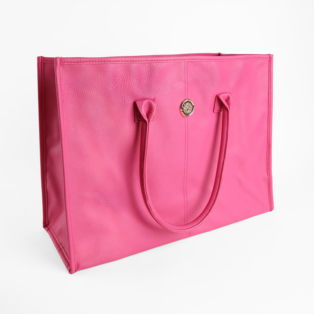 The Raspberry Pink Tote Bag is a bright pink rectangular faux leather tote featuring two handles and a small circular gold emblem on the front, set against a plain white background.